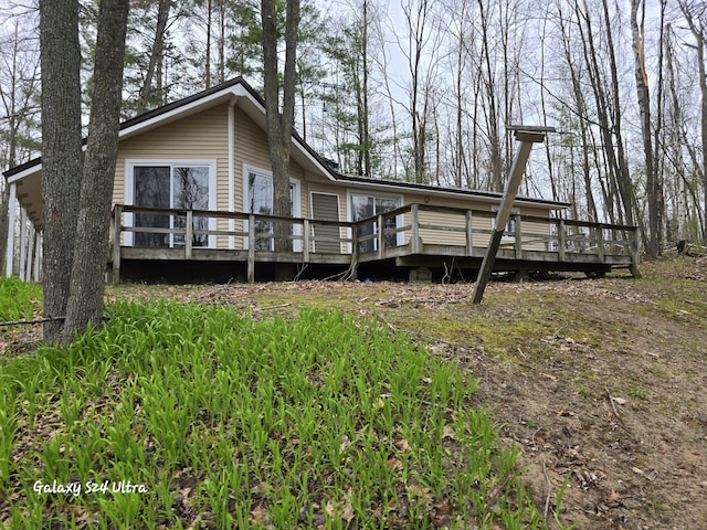 4591 Juneberry Trl, Gaylord, MI 49735 - back of property featuring a wooden deck