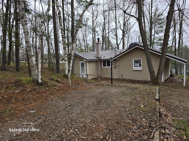 4591 Juneberry Trl, Gaylord, MI 49735 - view of front of property featuring a chimney and metal roof