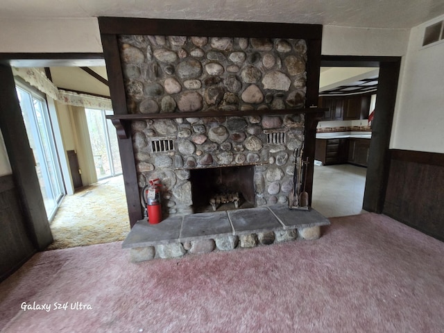 4591 Juneberry Trl, Gaylord, MI 49735 - detailed view of carpet floors, a fire extinguisher, and a stone fireplace