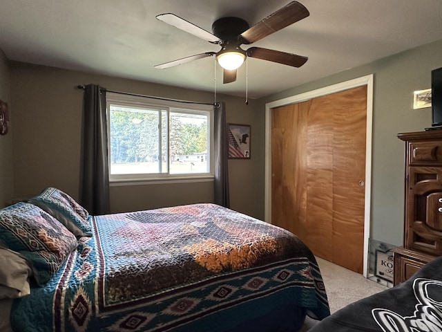 bedroom featuring a closet, light carpet, and a ceiling fan