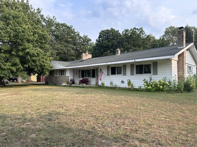 single story home featuring a front lawn and a chimney