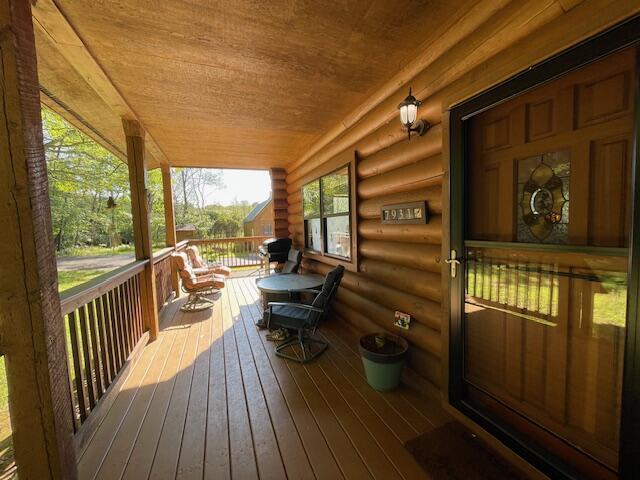 wooden terrace featuring covered porch