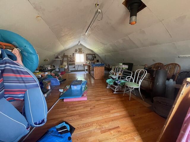 additional living space with lofted ceiling and wood finished floors