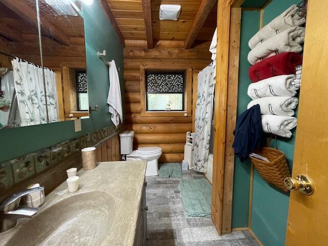 bathroom featuring beamed ceiling, toilet, a shower with shower curtain, wood ceiling, and vanity