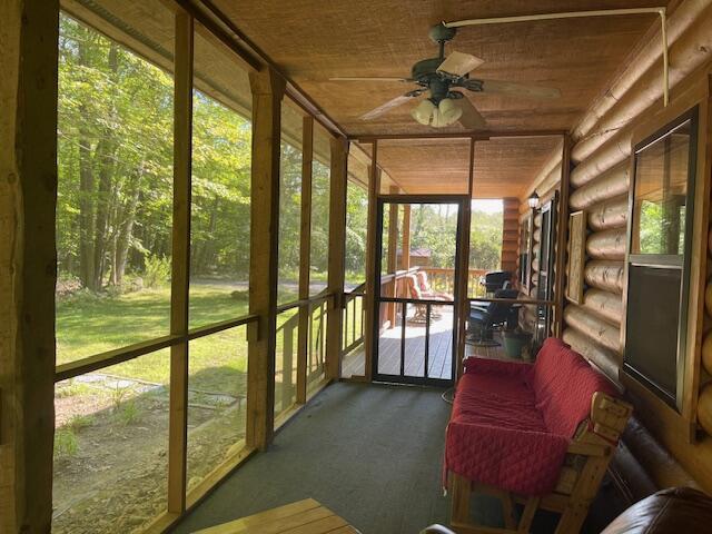 sunroom with wood ceiling and ceiling fan