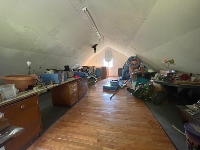 bonus room featuring vaulted ceiling and light wood finished floors