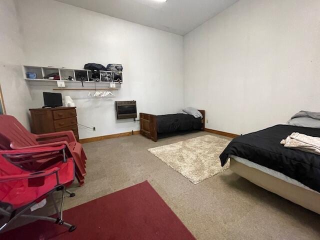 carpeted bedroom featuring baseboards and vaulted ceiling