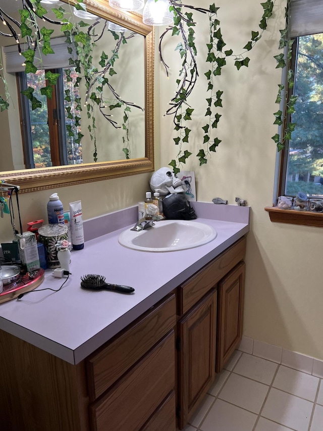 bathroom with tile patterned flooring, vanity, and baseboards