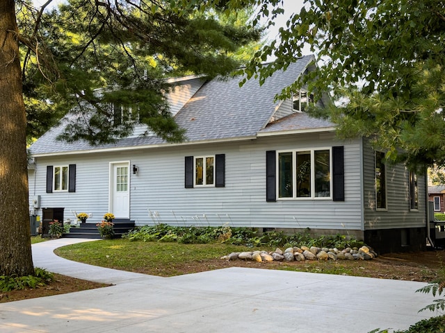 view of front of house with entry steps and a shingled roof