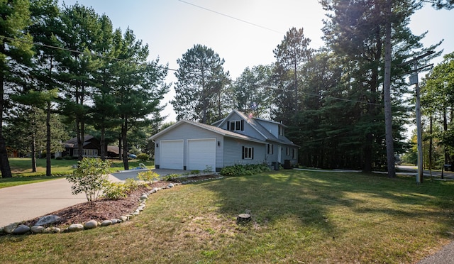view of property exterior with a garage, a yard, and driveway