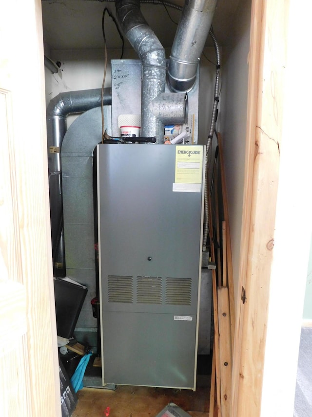 utility room featuring heating unit