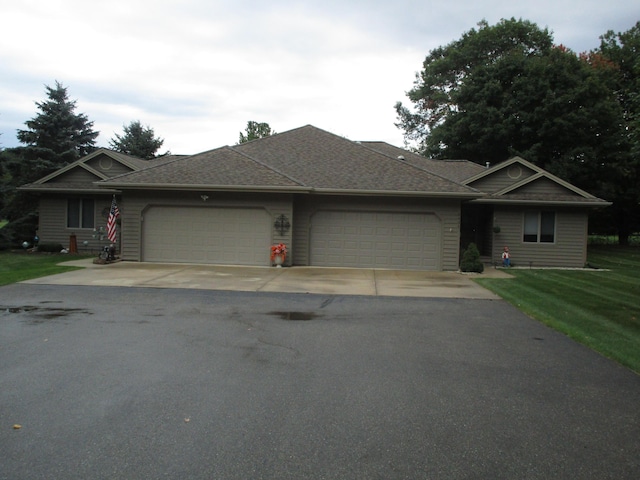 single story home with aphalt driveway, a front lawn, a garage, and a shingled roof