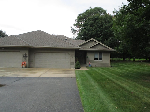 single story home featuring driveway, an attached garage, a front yard, and roof with shingles