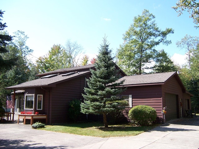 view of home's exterior with a garage and driveway