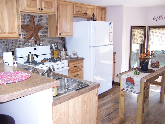 kitchen featuring white appliances, wood finished floors, tasteful backsplash, and light brown cabinetry