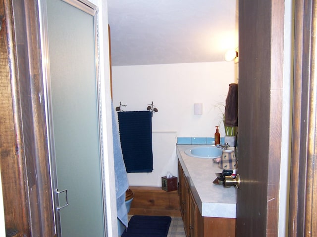 bathroom featuring an enclosed shower and vanity