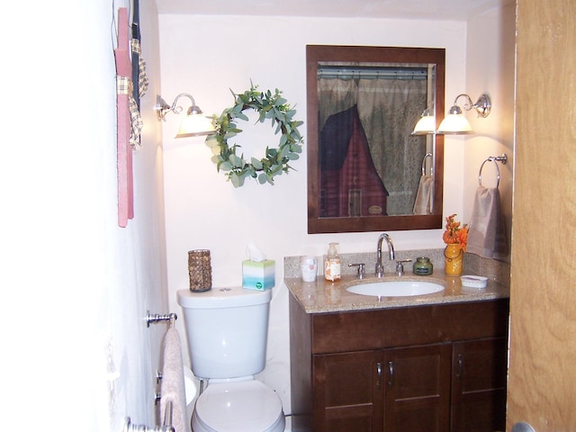 bathroom with toilet and vanity