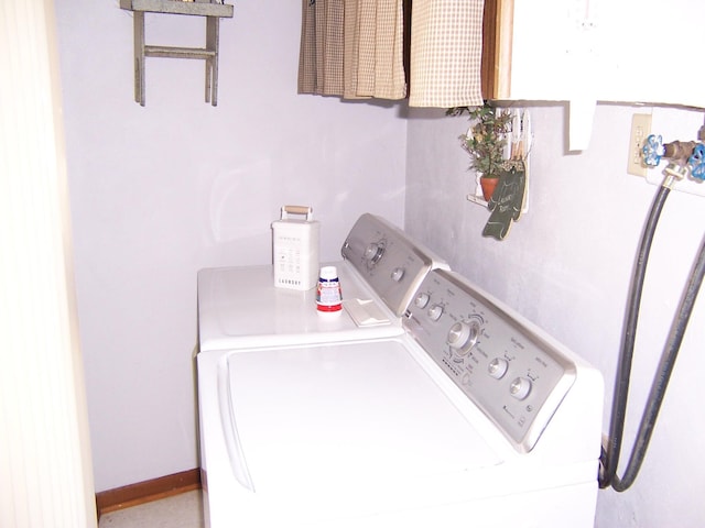 laundry area featuring washer and dryer, laundry area, and baseboards