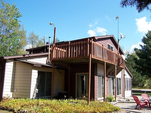 back of house with a wooden deck