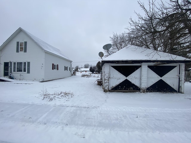 snow covered structure featuring an outdoor structure