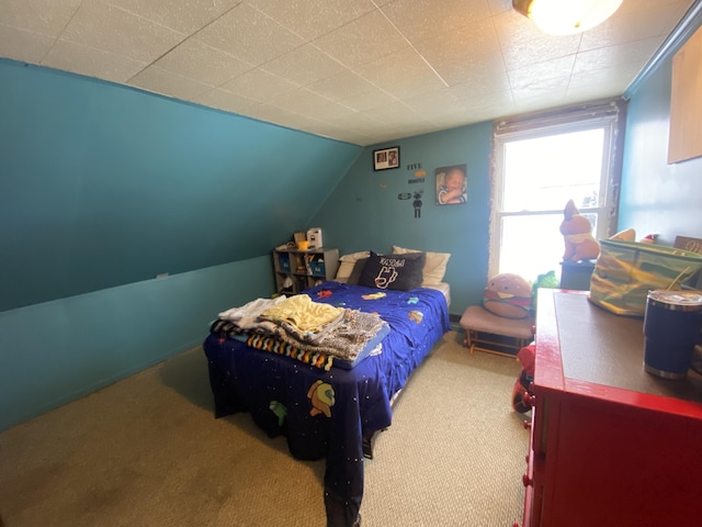 carpeted bedroom with lofted ceiling