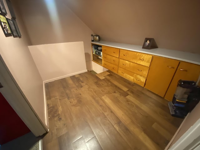 bathroom with vaulted ceiling and wood finished floors