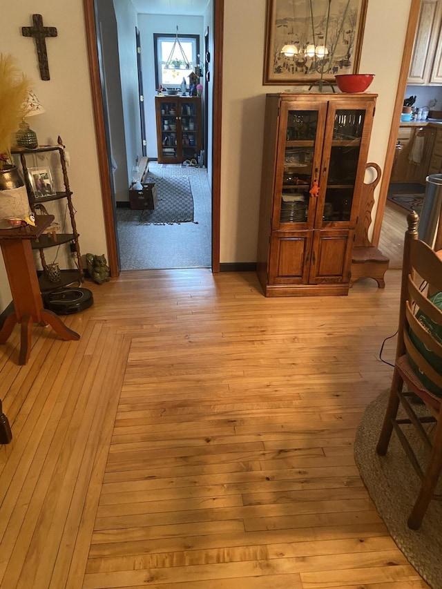 dining space with baseboards and light wood-style flooring