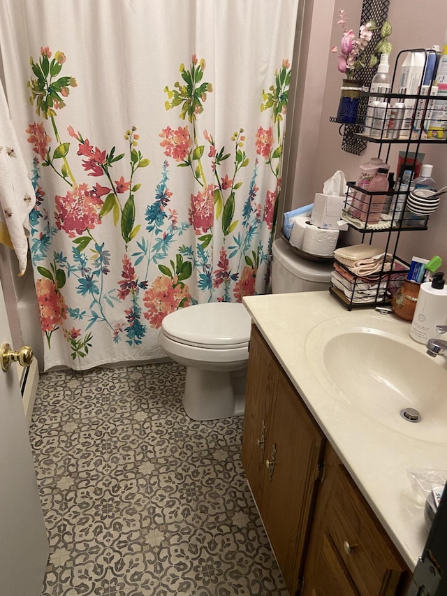 full bathroom with shower / bath combo with shower curtain, toilet, and vanity