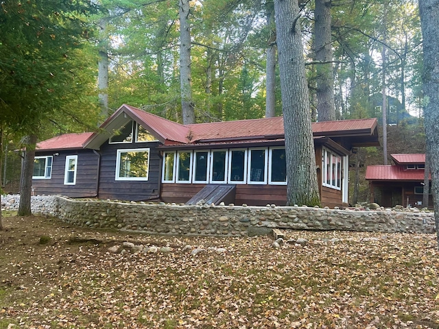 back of property featuring metal roof