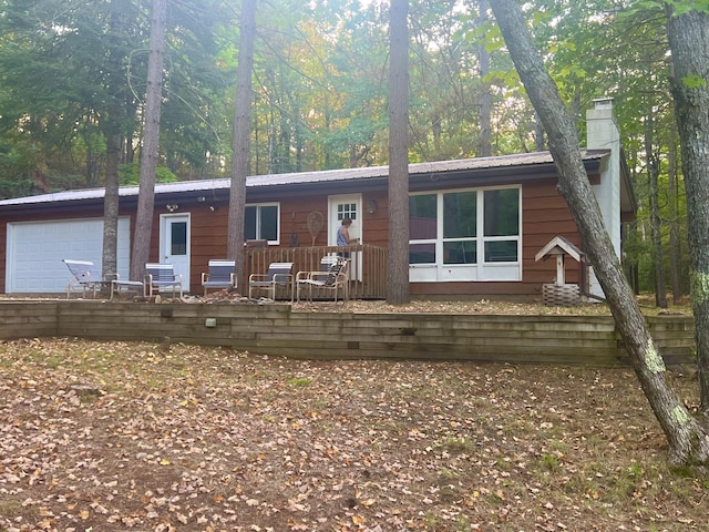 view of front of property with a chimney and metal roof