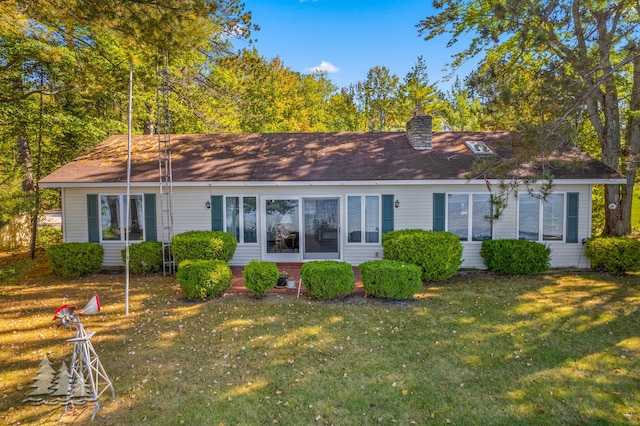 back of property with a lawn and a chimney