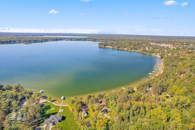 aerial view featuring a wooded view and a water view