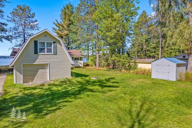 view of yard featuring an outbuilding, driveway, and a shed