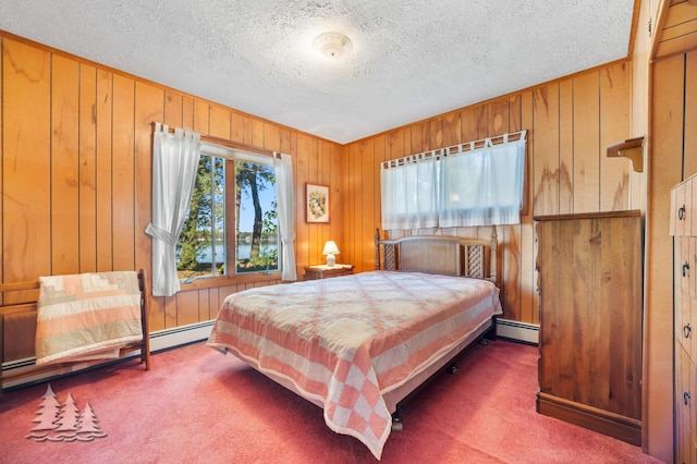 bedroom featuring a baseboard radiator, carpet, and wood walls