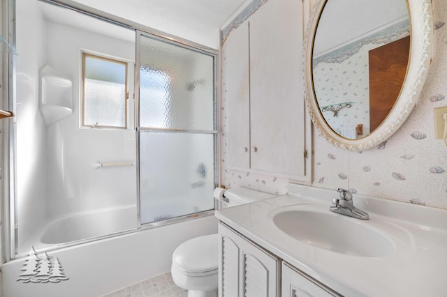 full bathroom with wallpapered walls, toilet, vanity, and shower / bath combination with glass door