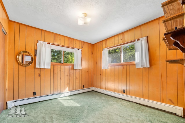 unfurnished room with plenty of natural light, a textured ceiling, and carpet flooring