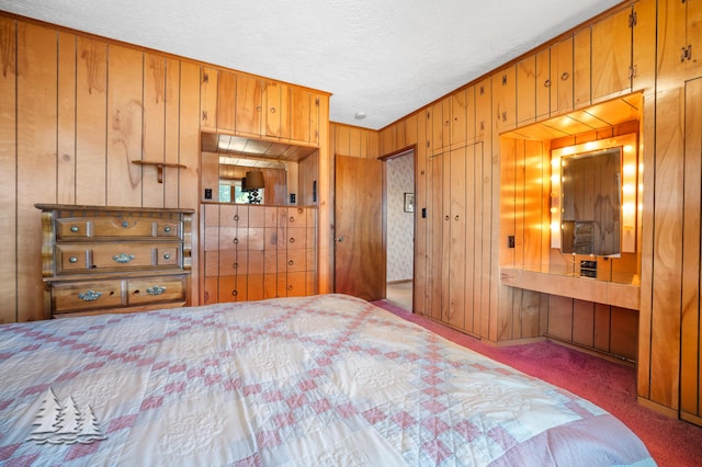 unfurnished bedroom featuring wooden walls, carpet, and a textured ceiling