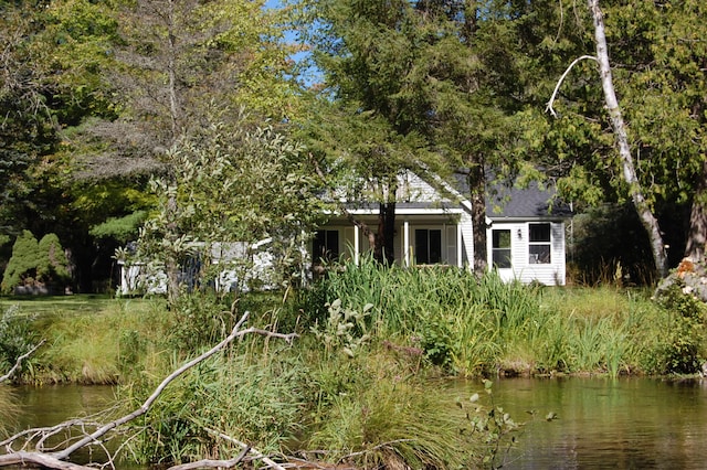 rear view of property with a water view