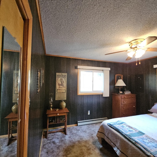 bedroom featuring carpet, ceiling fan, wood walls, a textured ceiling, and baseboard heating