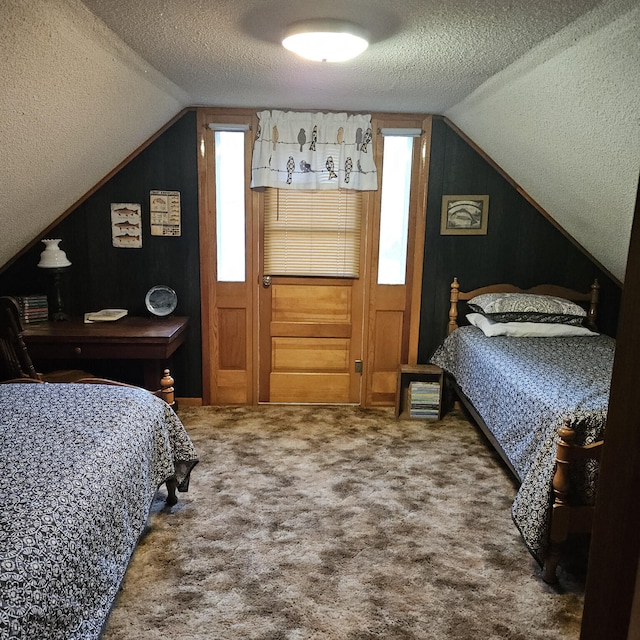 carpeted bedroom featuring a textured ceiling and vaulted ceiling