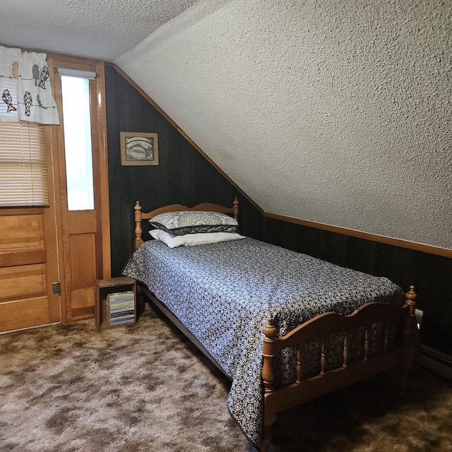 bedroom featuring carpet floors, a textured ceiling, and lofted ceiling