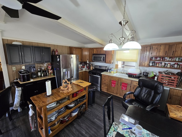 kitchen with lofted ceiling with beams, dark wood-style flooring, a sink, stainless steel appliances, and light countertops