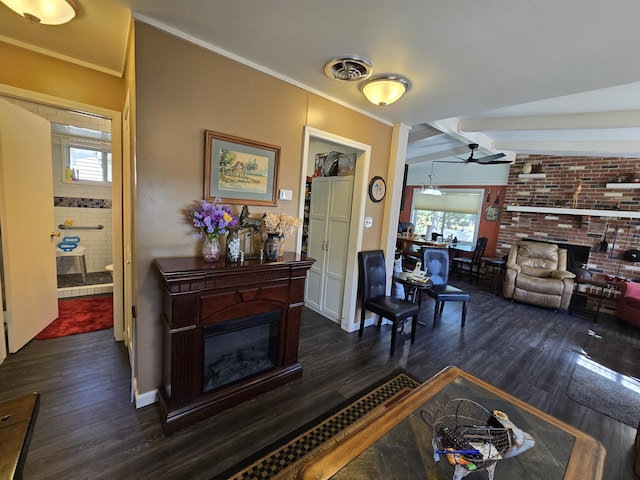 living room with visible vents, a brick fireplace, and dark wood-style flooring