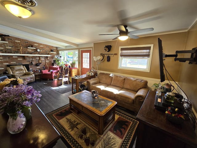 living room featuring wood finished floors, brick wall, and ceiling fan