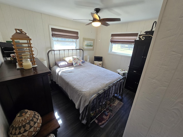 bedroom featuring ceiling fan and dark wood-style flooring