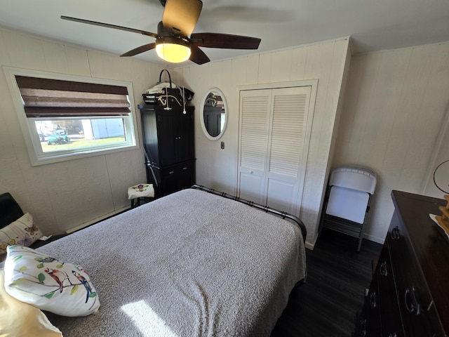 bedroom featuring a closet, ceiling fan, and dark wood-style flooring