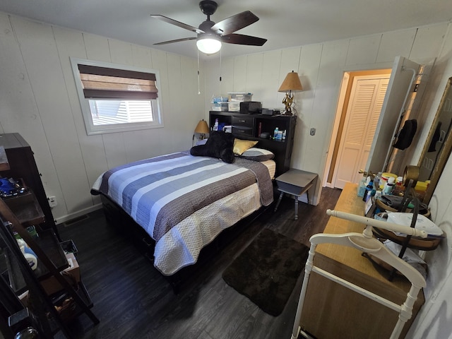 bedroom featuring ceiling fan, visible vents, and wood finished floors