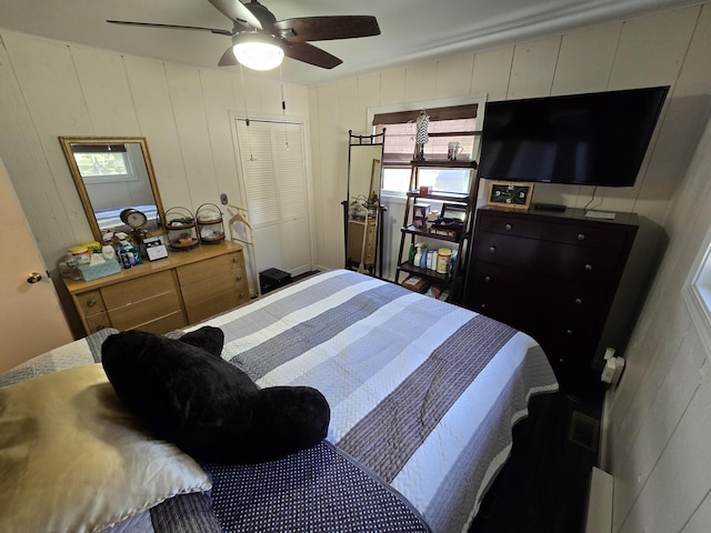 bedroom with multiple windows and ceiling fan