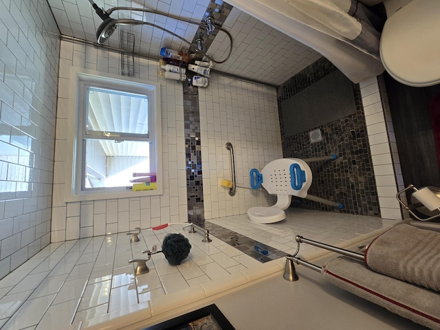 bathroom with tile patterned flooring and tile walls