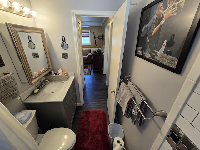 bathroom with vanity, toilet, and wood finished floors